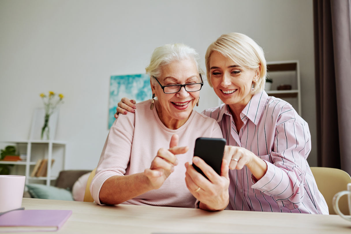 elderly senior with caregiver at table